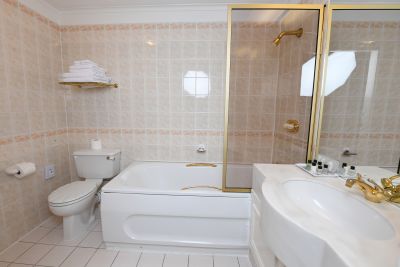En suite with shower over bathtub
